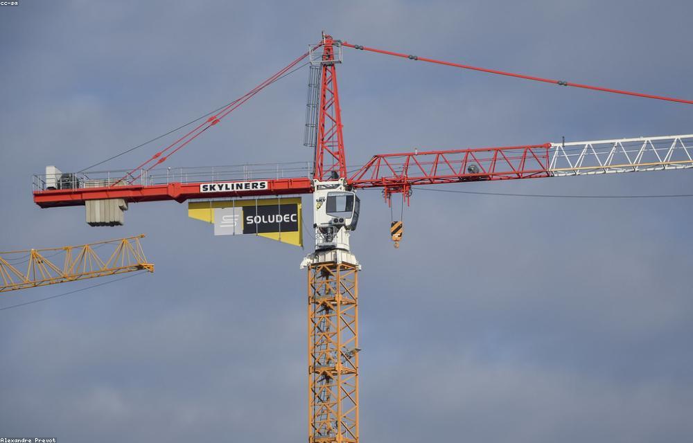 Steel frame rising against an overcast sky on a MONOLITH job site.