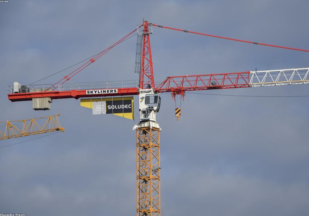 A superintendent reviewing progress from a tower crane platform.