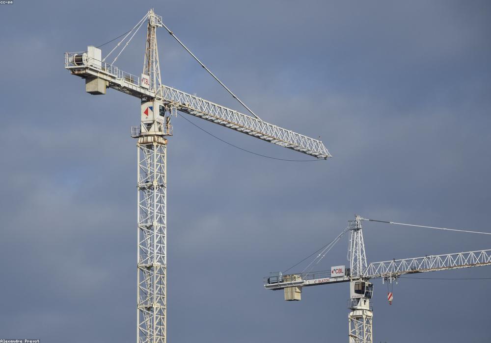 Ironworkers bolting a steel moment connection at height.